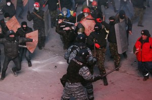 Pro-European integration protesters clash with Ukranian riot police during a rally near government administration buildings in Kiev