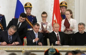 Russian President Putin, chief of Crimea's government Aksyonov, Crimean parliamentary speaker Konstantinov and Sevastopol Mayor Chaliy attend a signing ceremony at the Kremlin in Moscow