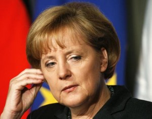 Germany's Chancellor Angela Merkel listens to a question at a joint news conference in Trieste