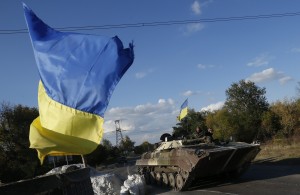 Ukrainian servicemen drive an armoured vehicle on the road near the eastern Ukrainian town of Horlivka